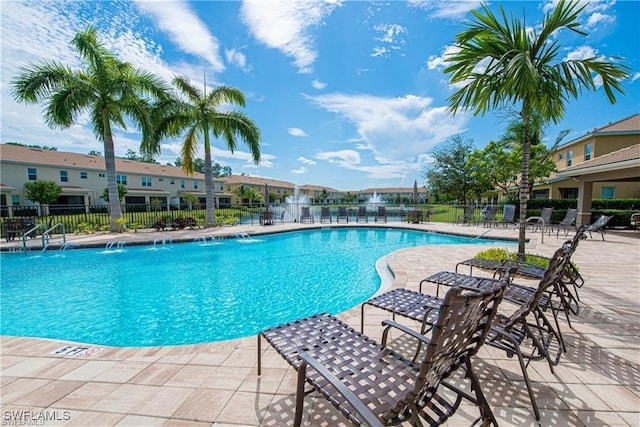 view of pool with pool water feature and a patio area