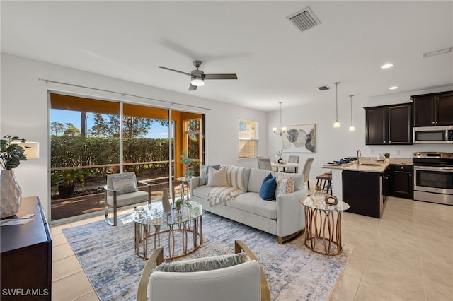 tiled living room with sink and ceiling fan