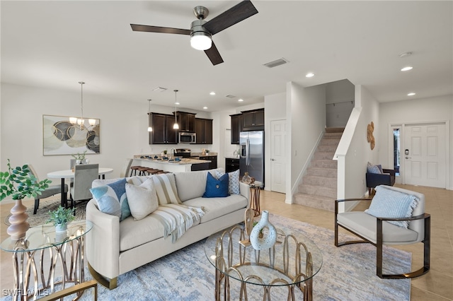 living room with ceiling fan with notable chandelier