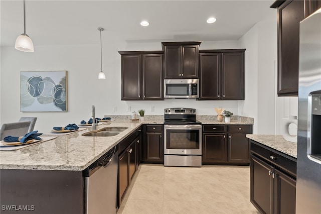 kitchen with light tile patterned flooring, sink, hanging light fixtures, stainless steel appliances, and dark brown cabinets