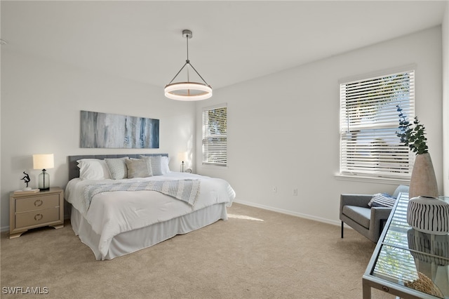 carpeted bedroom featuring multiple windows