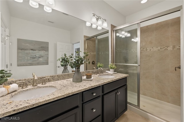 bathroom featuring an enclosed shower, vanity, and tile patterned floors