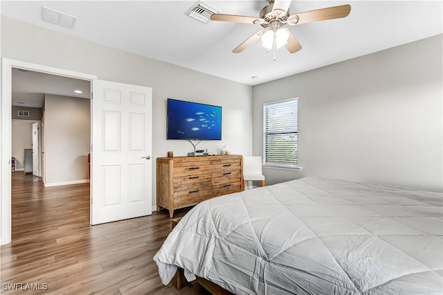 bedroom with ceiling fan and wood-type flooring