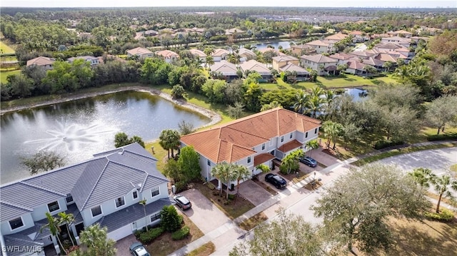 drone / aerial view featuring a residential view and a water view