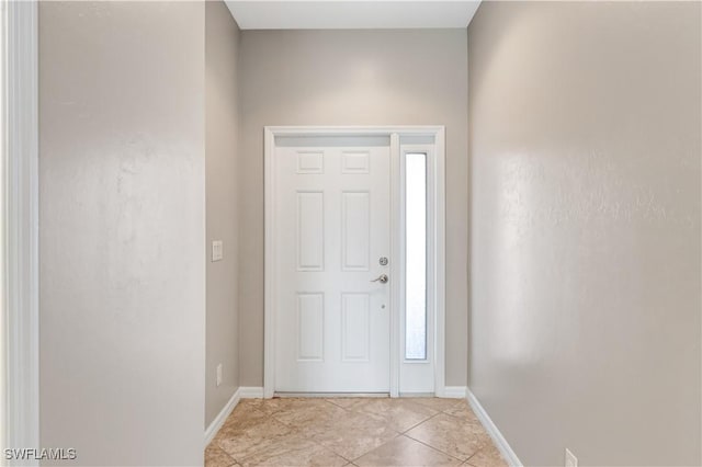 entrance foyer featuring baseboards and light tile patterned floors