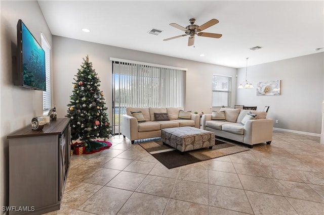 living room with visible vents, ceiling fan, baseboards, and light tile patterned floors