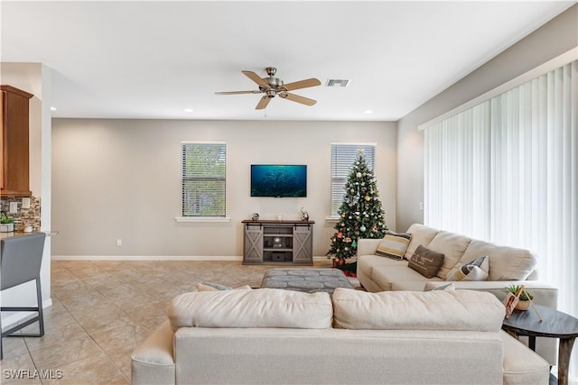 living area featuring light tile patterned floors, baseboards, visible vents, a ceiling fan, and recessed lighting