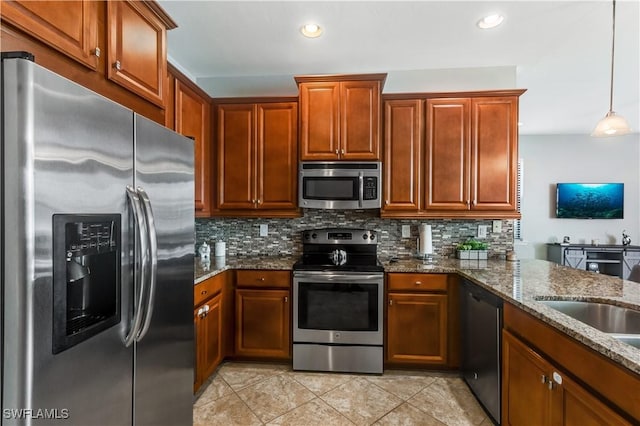 kitchen with tasteful backsplash, dark stone counters, stainless steel appliances, light tile patterned floors, and hanging light fixtures