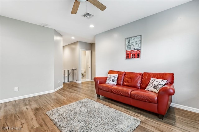 living room with recessed lighting, wood finished floors, visible vents, and baseboards