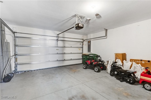 garage featuring electric panel and a garage door opener