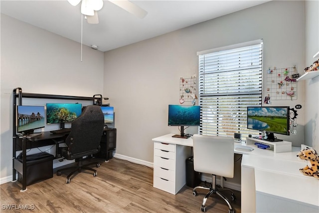 office featuring baseboards, light wood-style flooring, and a ceiling fan