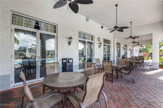 view of patio with outdoor dining space and ceiling fan