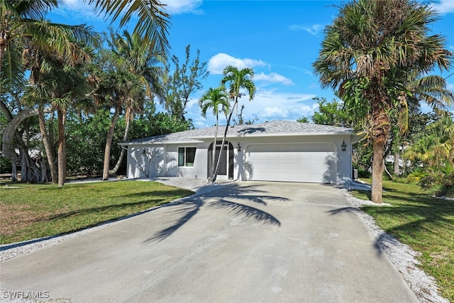 ranch-style home featuring a garage and a front lawn