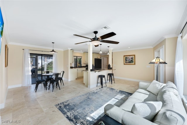 living room with ceiling fan and crown molding