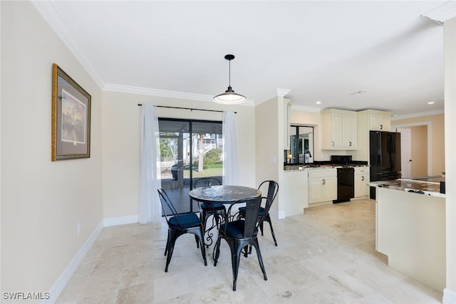 dining space with ornamental molding and sink