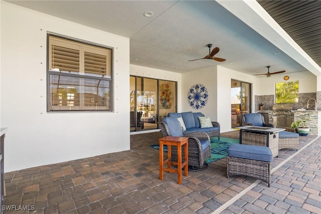 view of patio featuring an outdoor living space, an outdoor kitchen, and sink