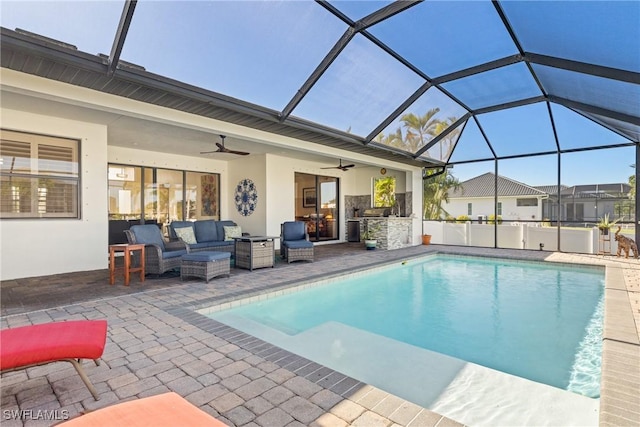 view of swimming pool featuring a patio area, ceiling fan, outdoor lounge area, and glass enclosure