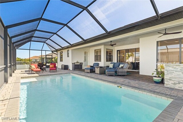 view of pool featuring a lanai, ceiling fan, a patio, and an outdoor living space