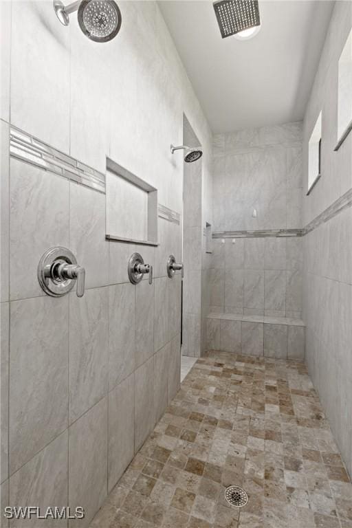 bathroom with a tile shower