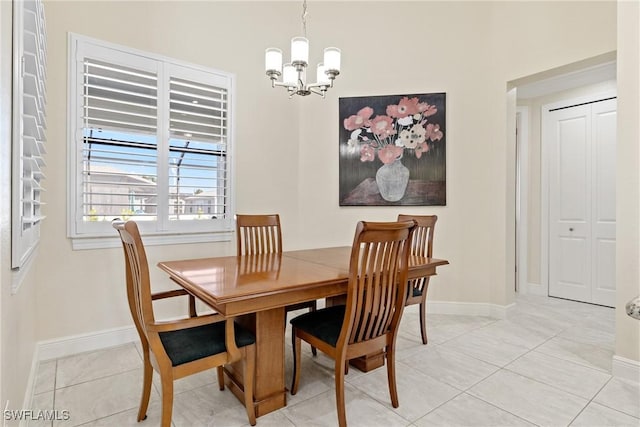 dining room featuring a notable chandelier and light tile patterned flooring