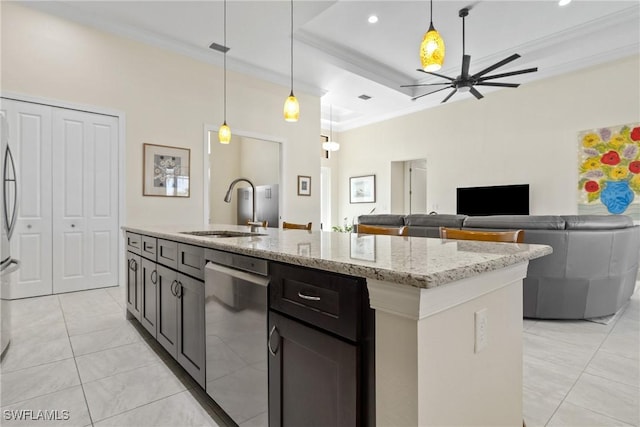 kitchen featuring crown molding, light stone counters, sink, and hanging light fixtures