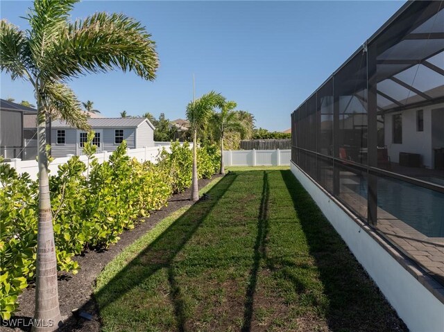 view of yard featuring glass enclosure