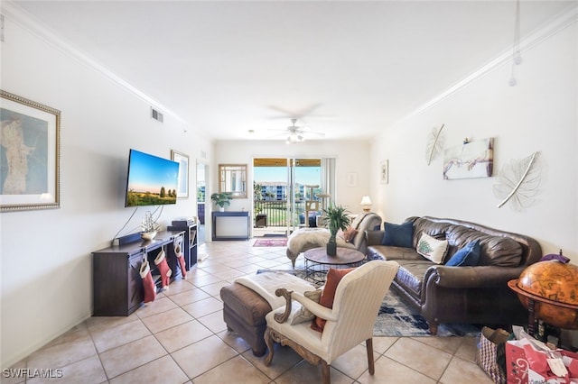 living room with crown molding, light tile patterned floors, and ceiling fan