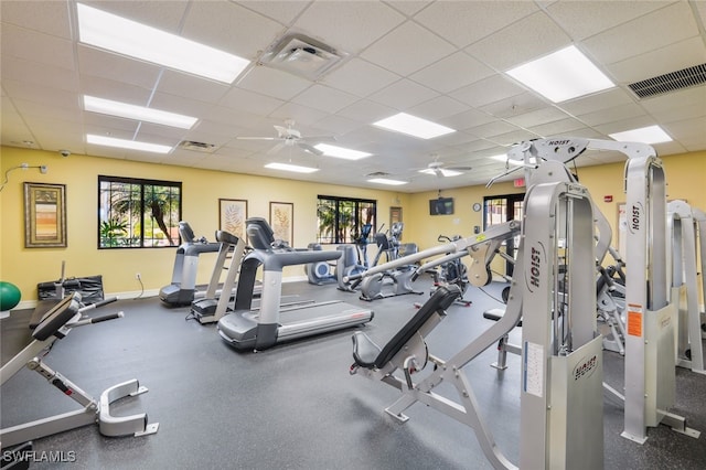 gym with ceiling fan and a paneled ceiling