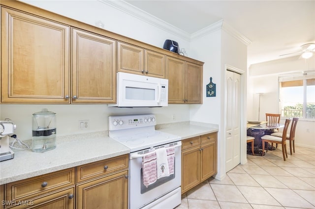 kitchen with light tile patterned floors, crown molding, white appliances, ceiling fan, and light stone countertops