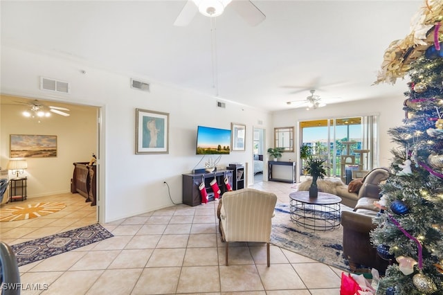 living room with light tile patterned flooring, crown molding, and ceiling fan