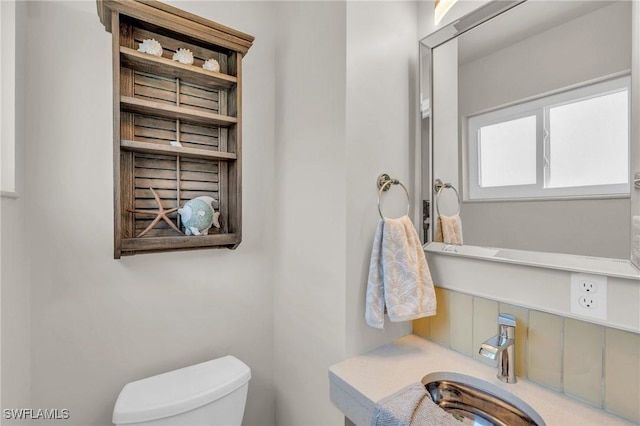 bathroom with toilet and a sink