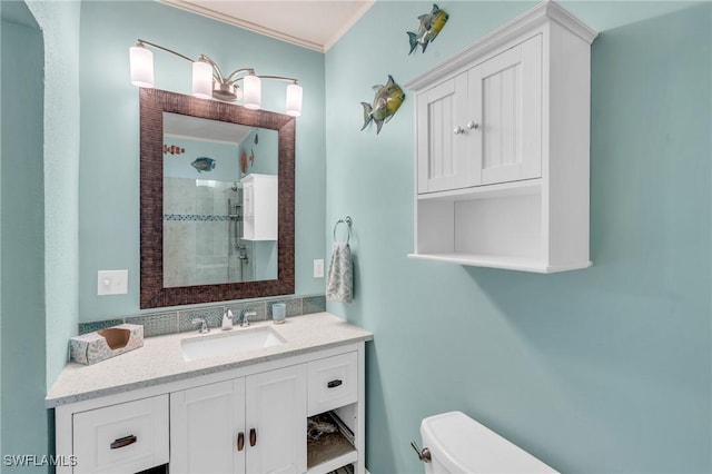 bathroom featuring a shower stall, toilet, and vanity