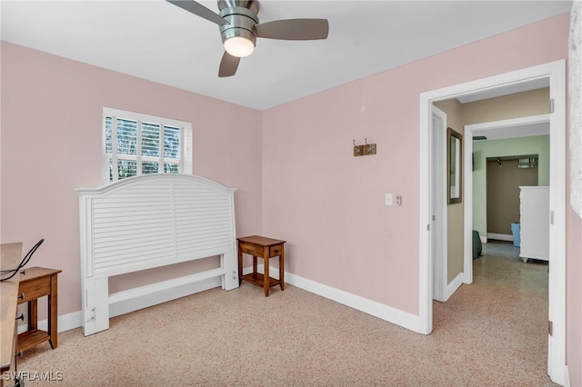 interior space with baseboards, light speckled floor, and a ceiling fan