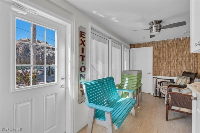 sunroom with visible vents and a ceiling fan