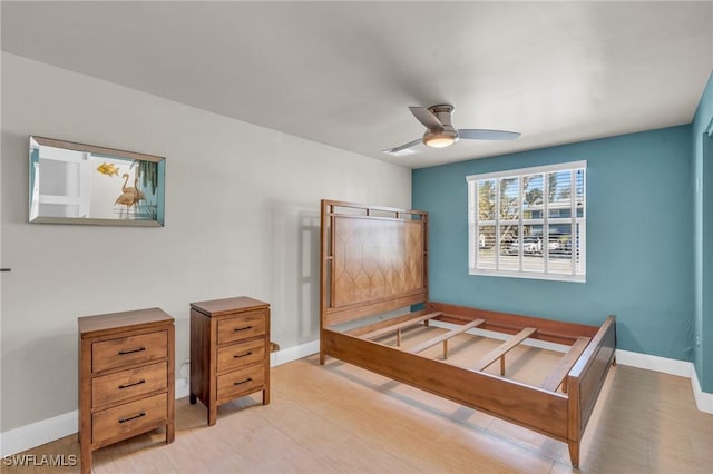 bedroom with light wood finished floors, ceiling fan, and baseboards