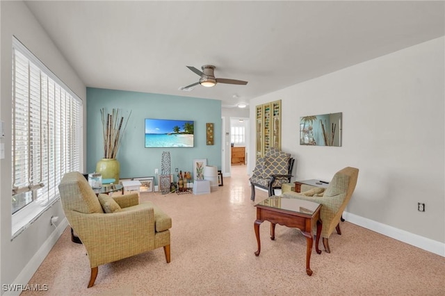 sitting room featuring baseboards and a ceiling fan