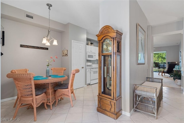 dining room featuring a chandelier and light tile patterned floors