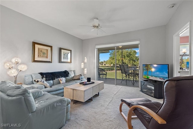 carpeted living room with ceiling fan