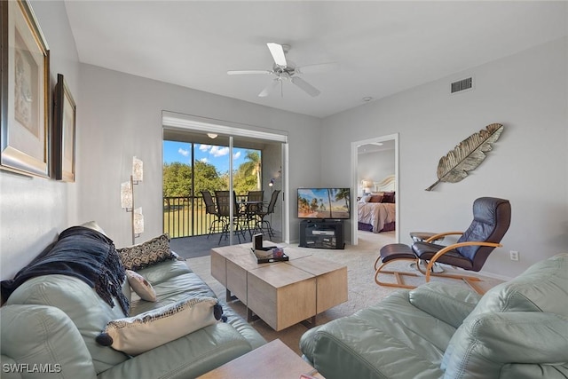 living room featuring ceiling fan and light colored carpet