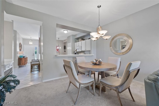 carpeted dining area featuring an inviting chandelier