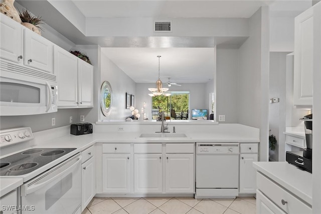 kitchen with white appliances, white cabinetry, and sink