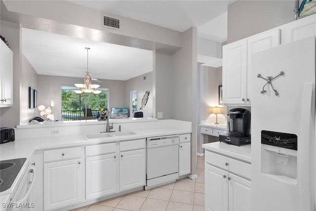 kitchen with white appliances, sink, a notable chandelier, white cabinetry, and light tile patterned flooring