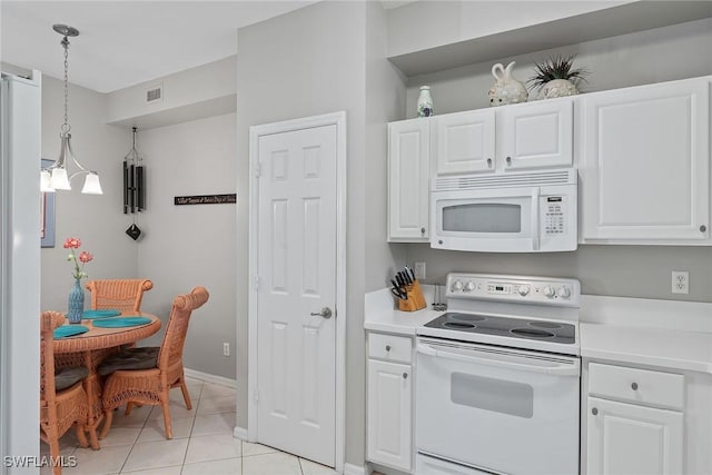 kitchen featuring pendant lighting, white appliances, white cabinets, light tile patterned floors, and a chandelier