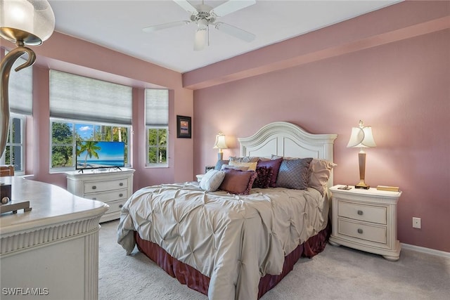 bedroom with light carpet and ceiling fan