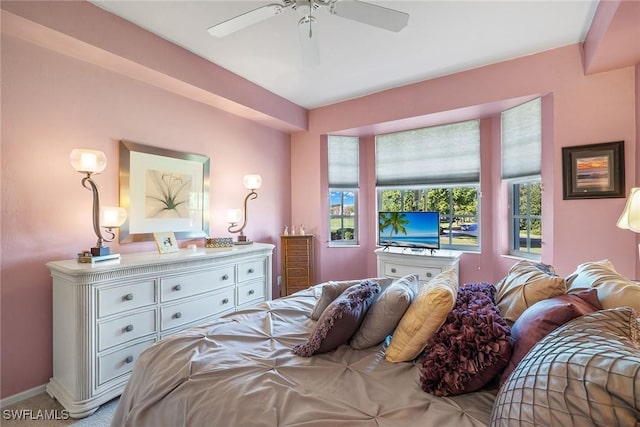 bedroom with ceiling fan and light carpet