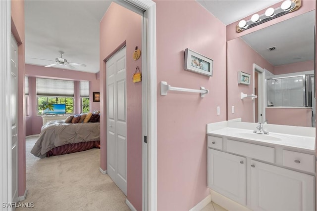 bathroom featuring an enclosed shower, vanity, and ceiling fan