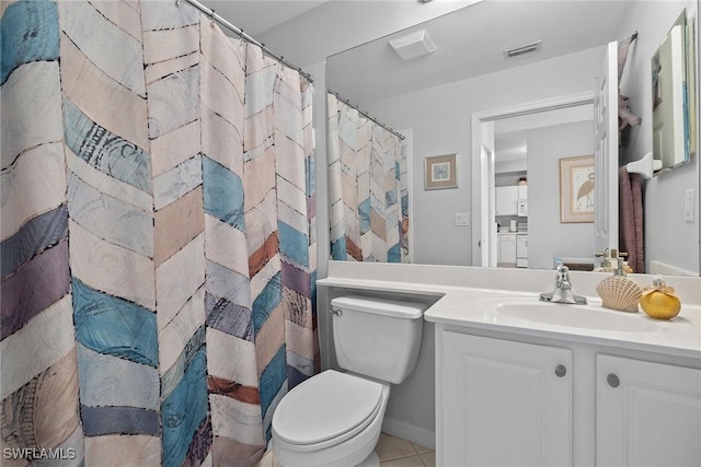 bathroom featuring tile patterned floors, a shower with curtain, vanity, and toilet