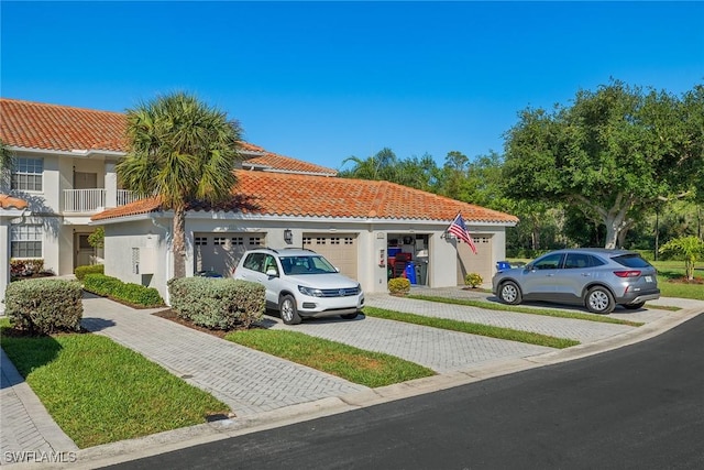 mediterranean / spanish home featuring a garage