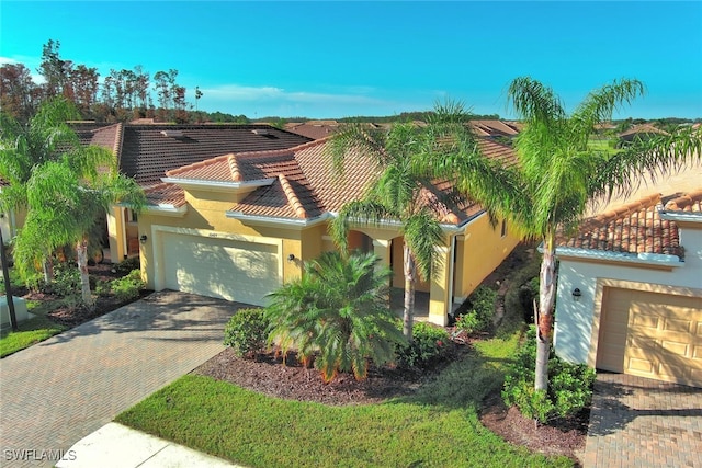 mediterranean / spanish-style home with a garage