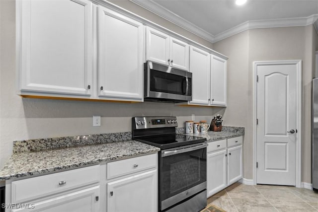 kitchen with white cabinets, appliances with stainless steel finishes, light stone counters, and crown molding